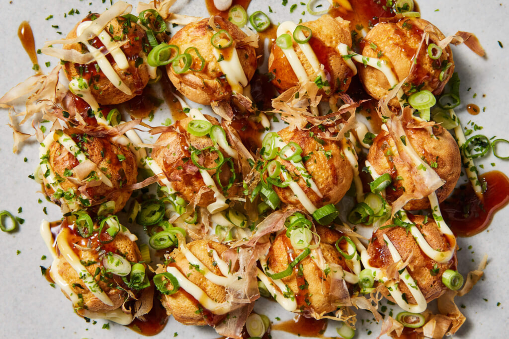 Takoyaki is a ball-shaped Japanese snack made of a wheat flour-based batter and cooked in a special molded pan.